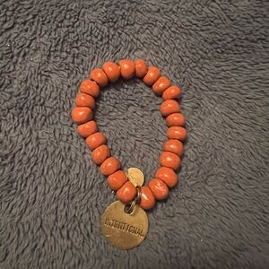 Red / Orange Beaded Bracelet with Gold Charm